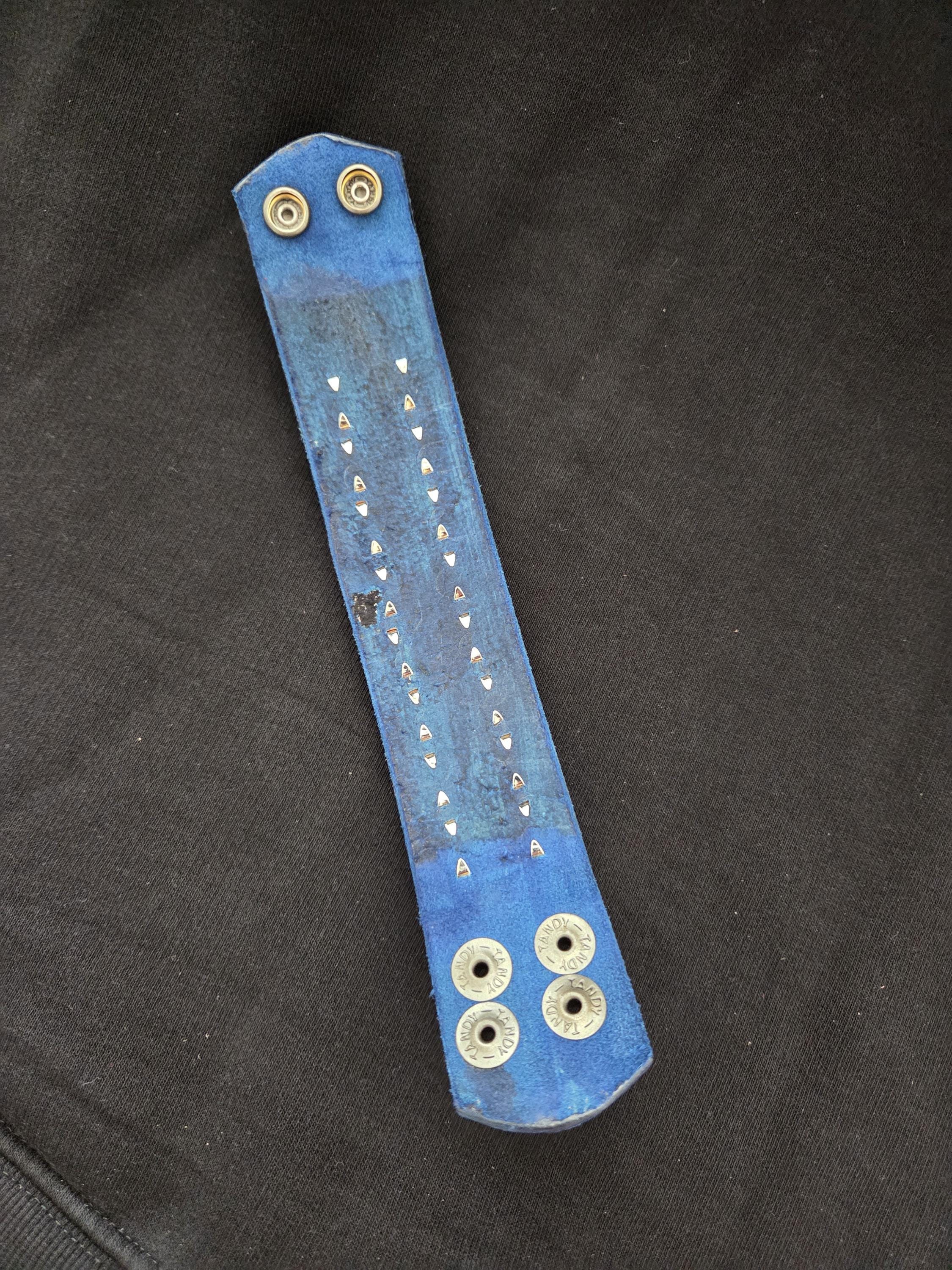 Studded leather punk wrist cuff.