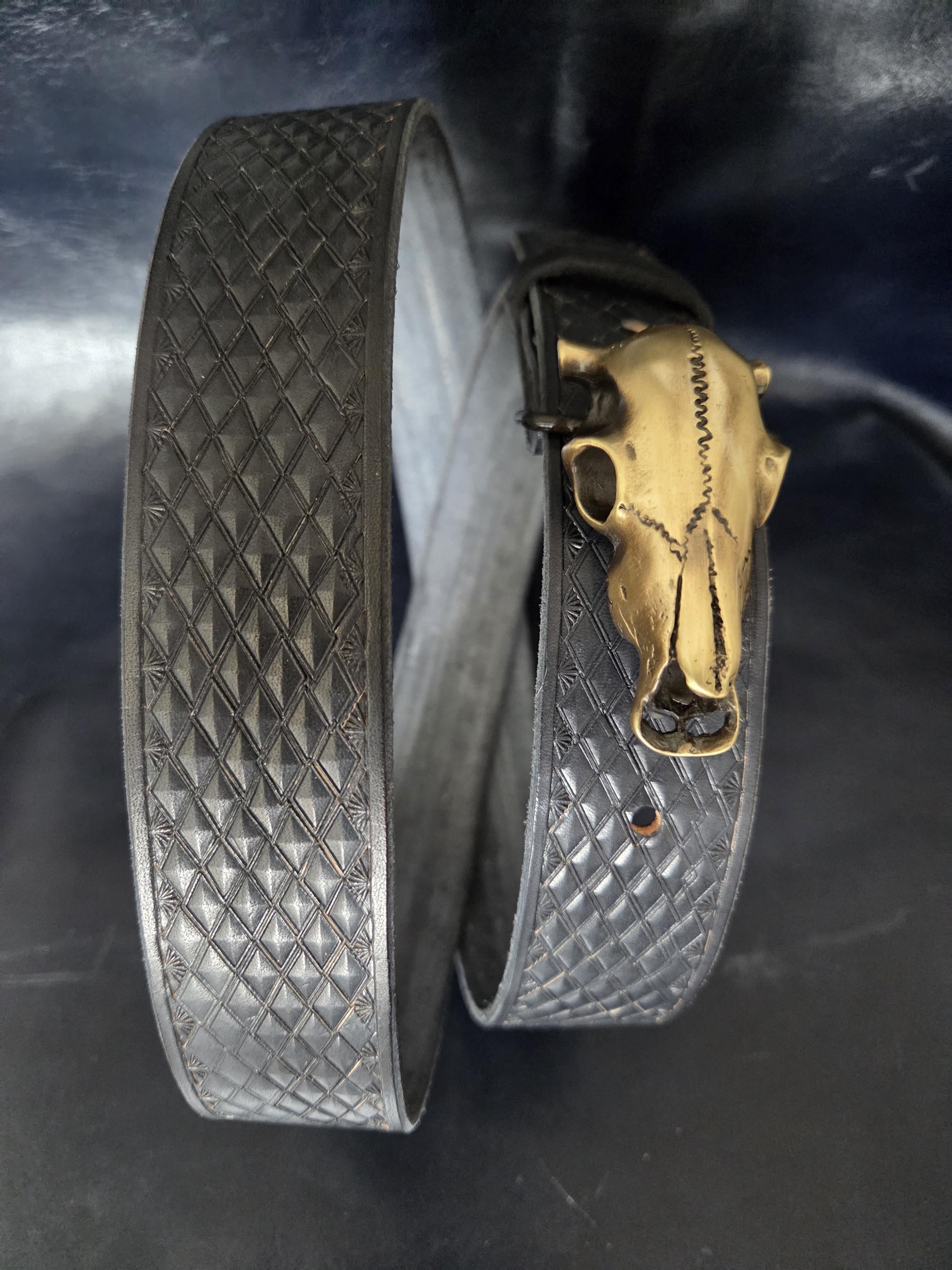 Stamped, black leather belt.