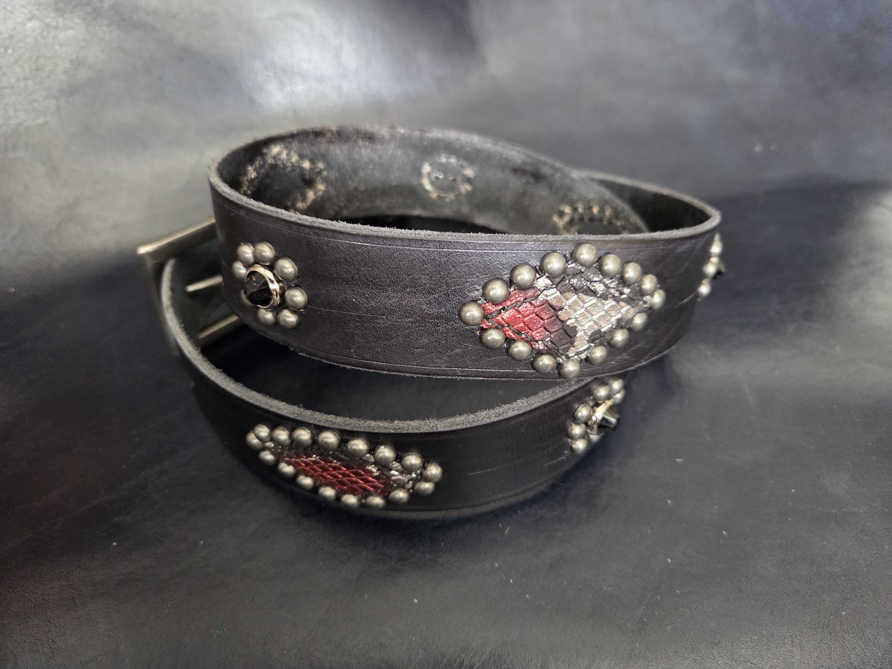 Handmade distressed leather belt with snakeskin print inlays.