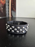 Studded leather punk wrist cuff.