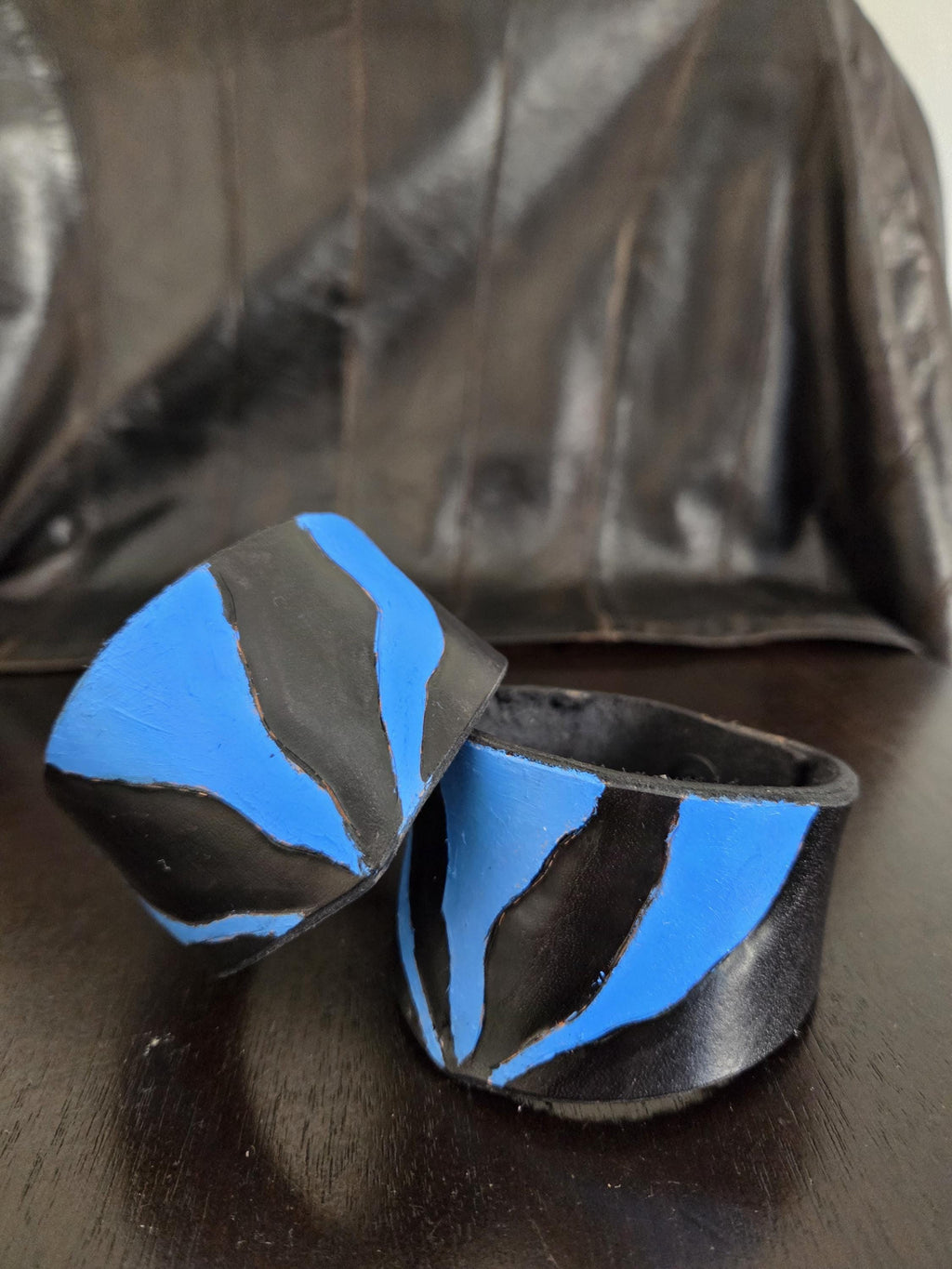 Black n' blue leathet wrist cuff bracelet.