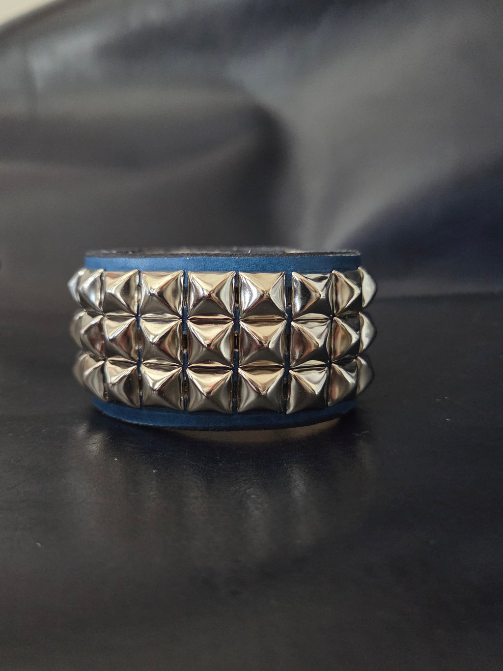 The "Defender" cuff. Available in red or blue.