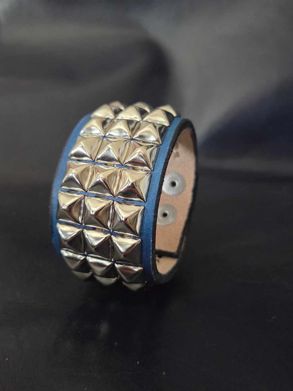 The "Defender" cuff. Available in red or blue.