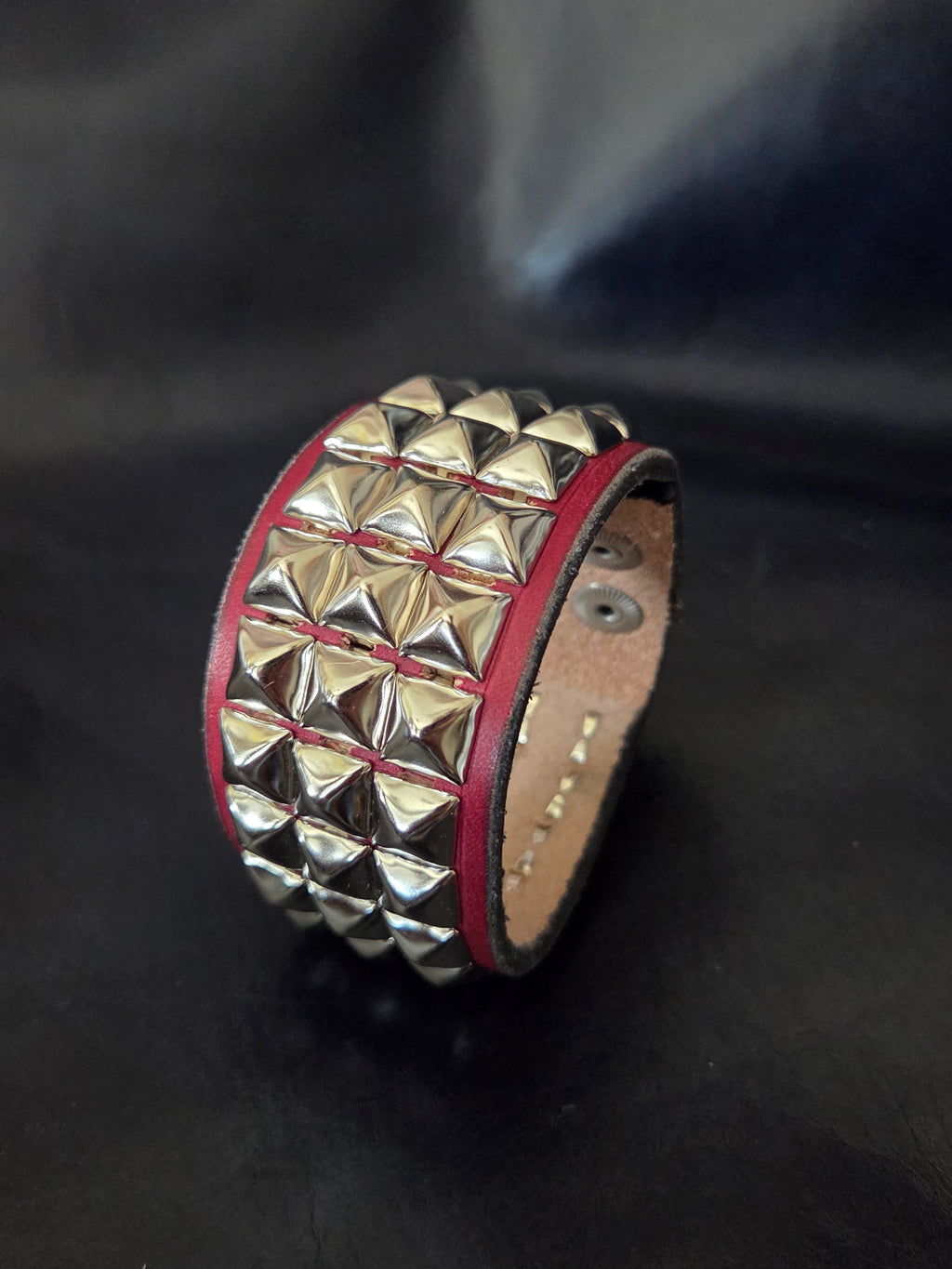 The "Defender" cuff. Available in red or blue.