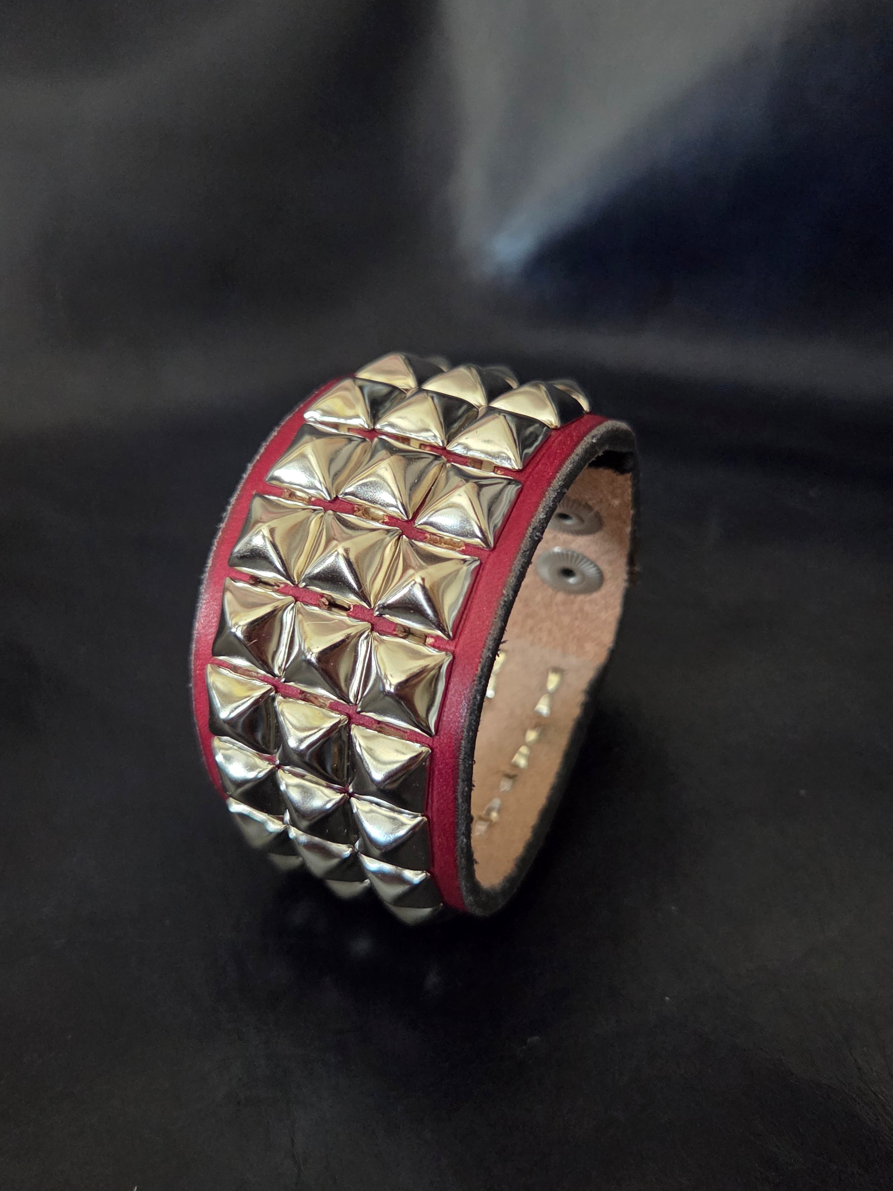 The "Defender" cuff. Available in red or blue.