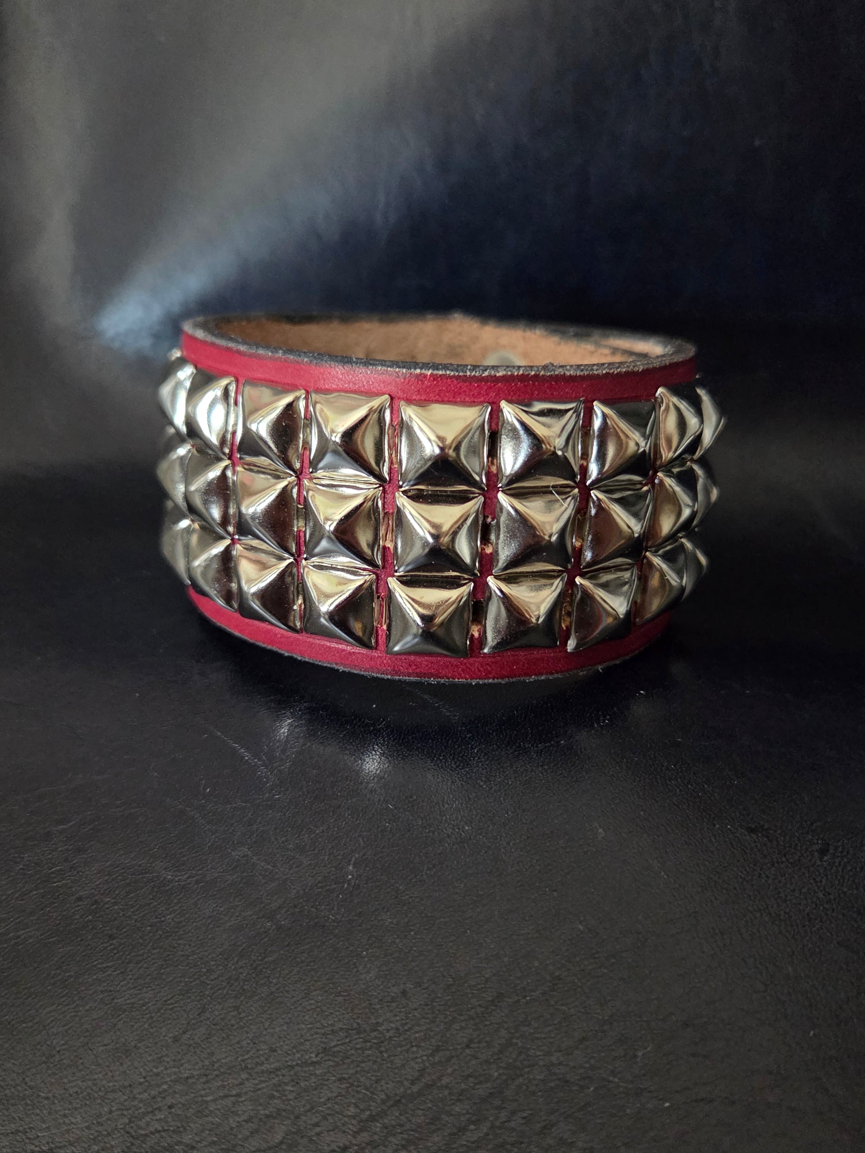 The "Defender" cuff. Available in red or blue.