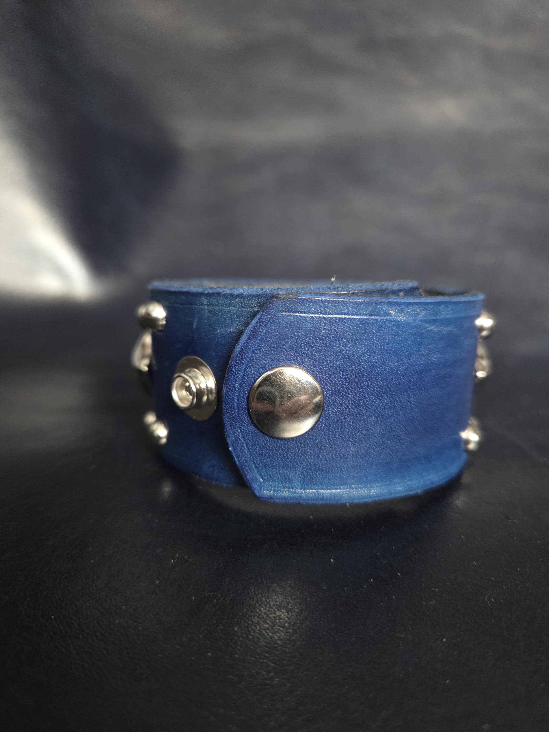 Blue leather wrist cuff.