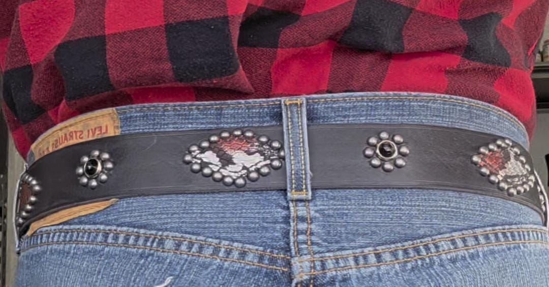 Handmade distressed leather belt with snakeskin print inlays.