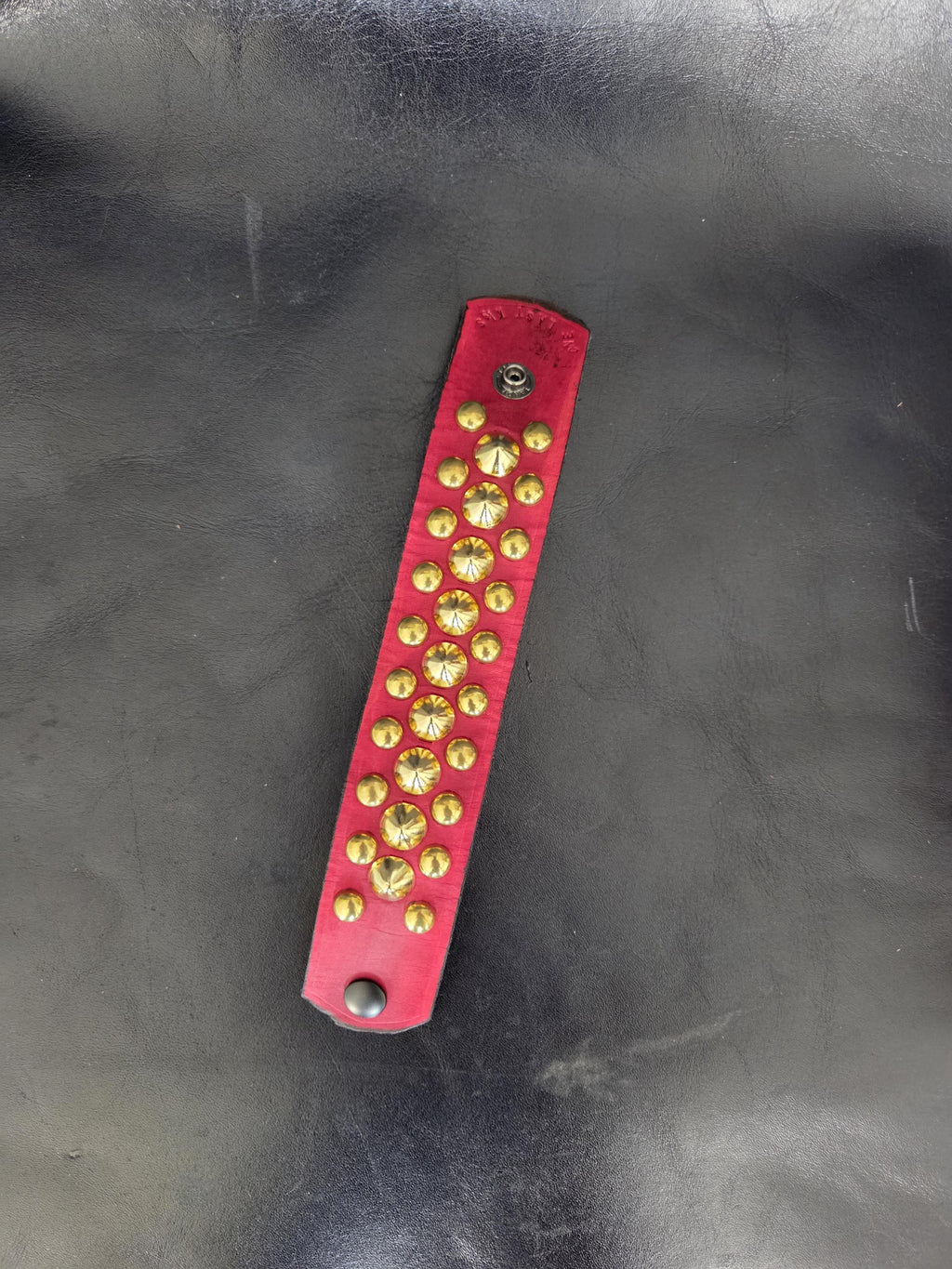 Red Punk studded wrist cuff.