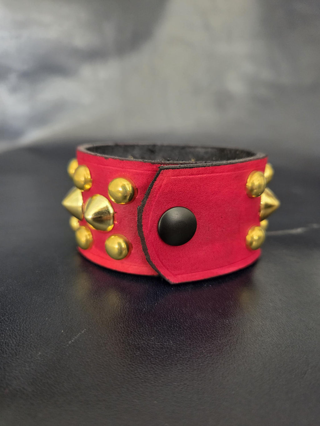 Red Punk studded wrist cuff.