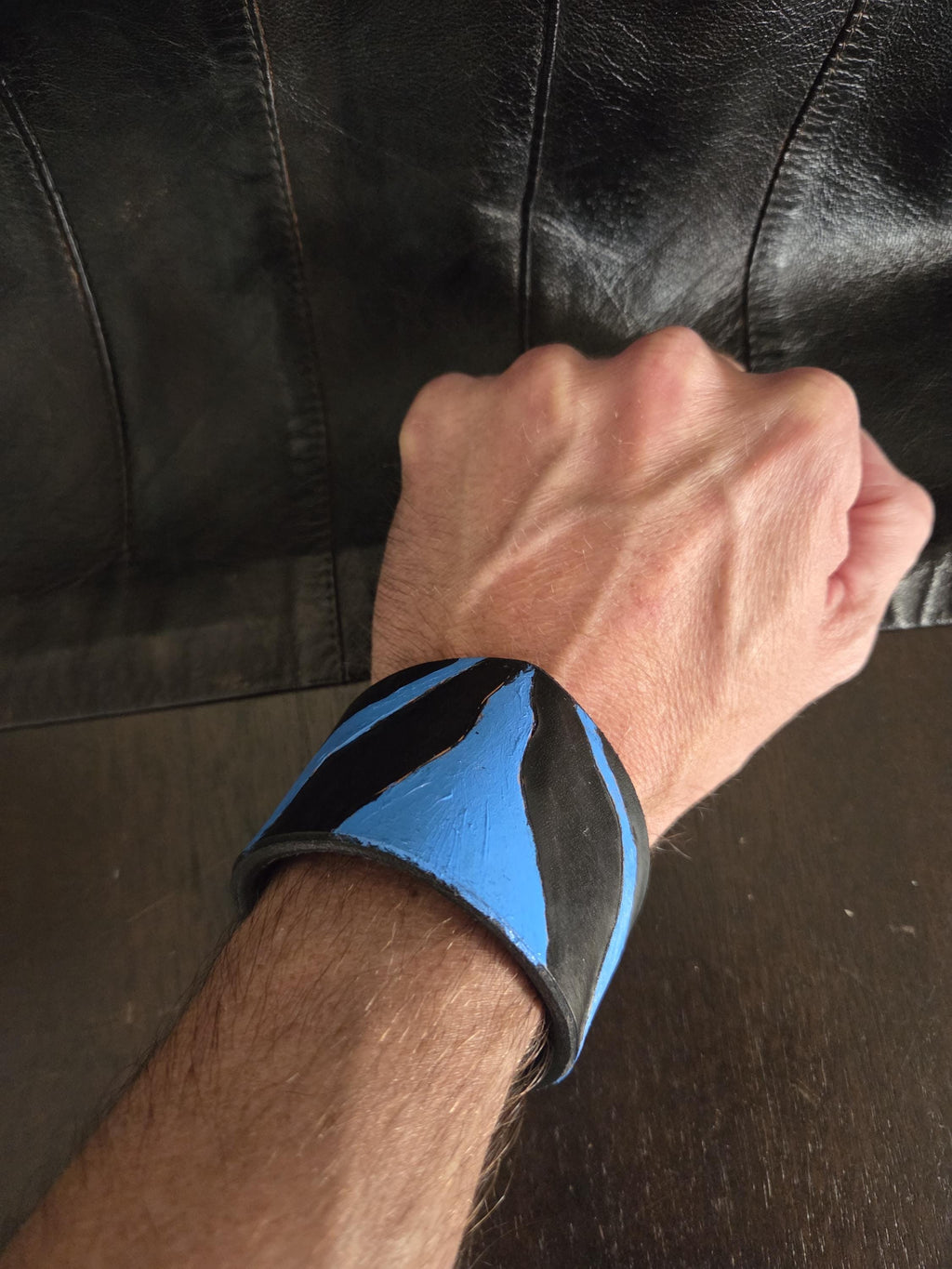 Black n' blue leathet wrist cuff bracelet.