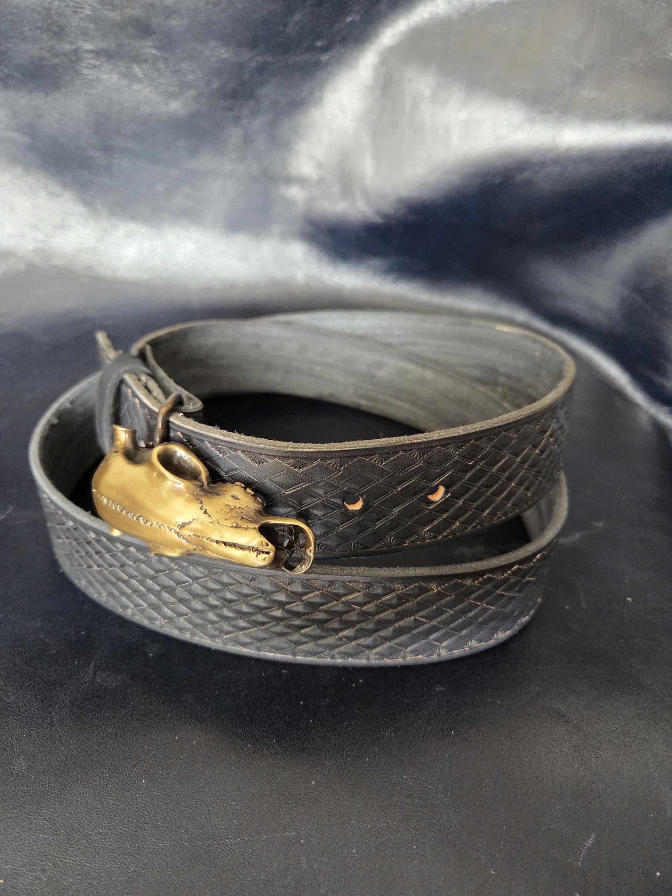 Stamped, black leather belt.