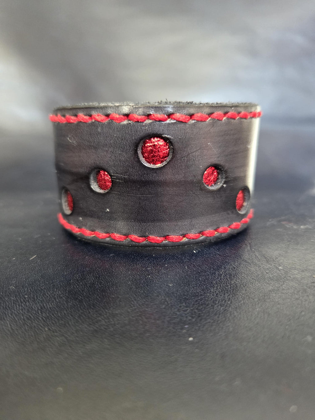Black and red leather wrist cuff.