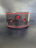 Black and red leather wrist cuff.