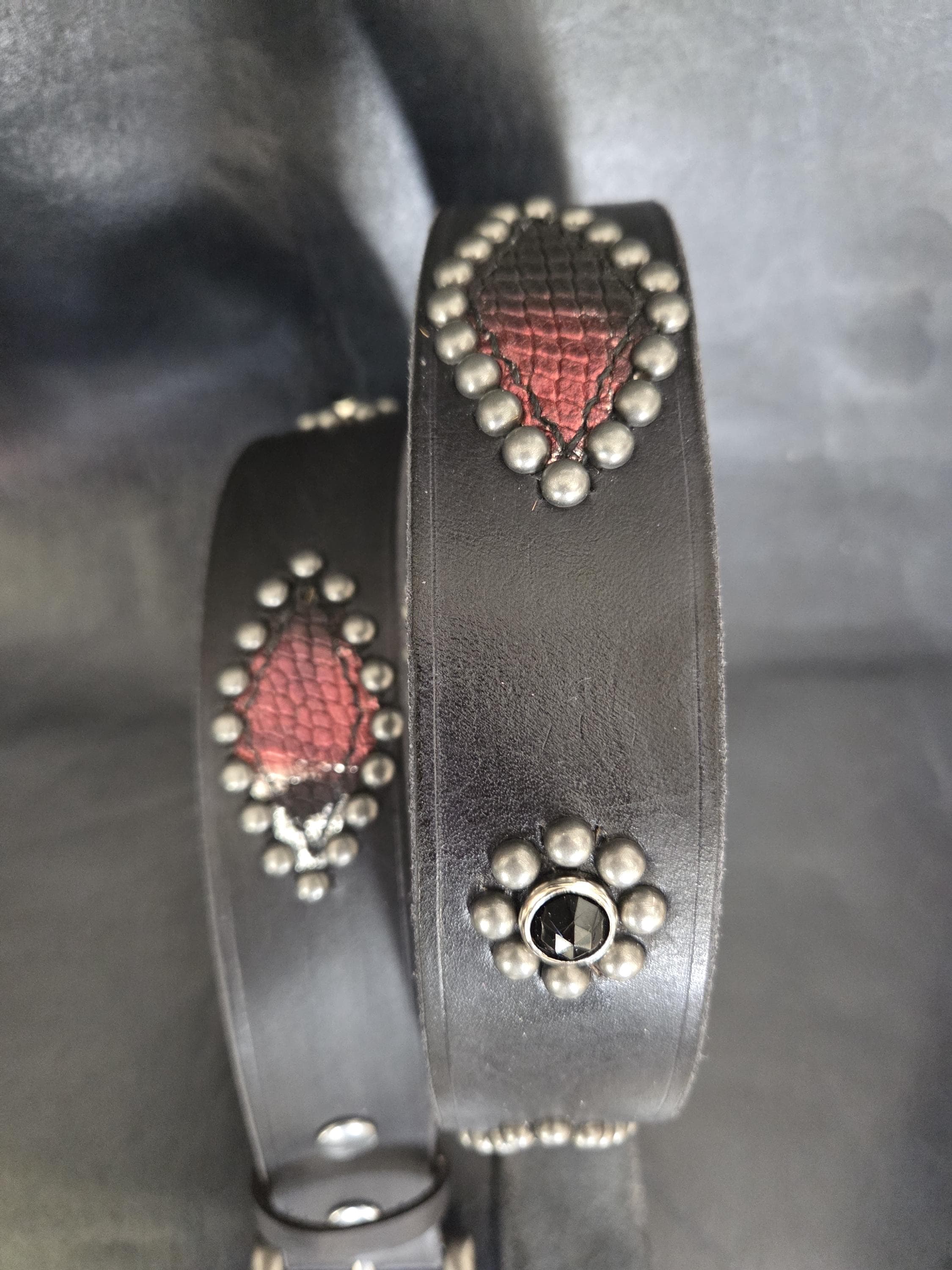 Handmade distressed leather belt with snakeskin print inlays.