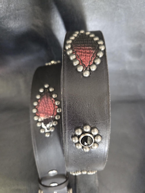 Handmade distressed leather belt with snakeskin print inlays.