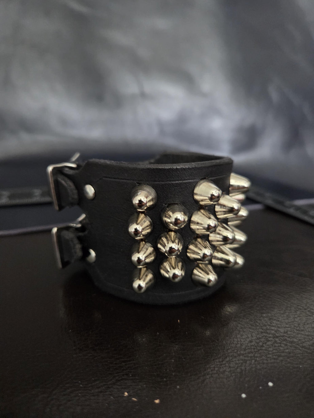 Punk leather studded wrist cuff with buckles.