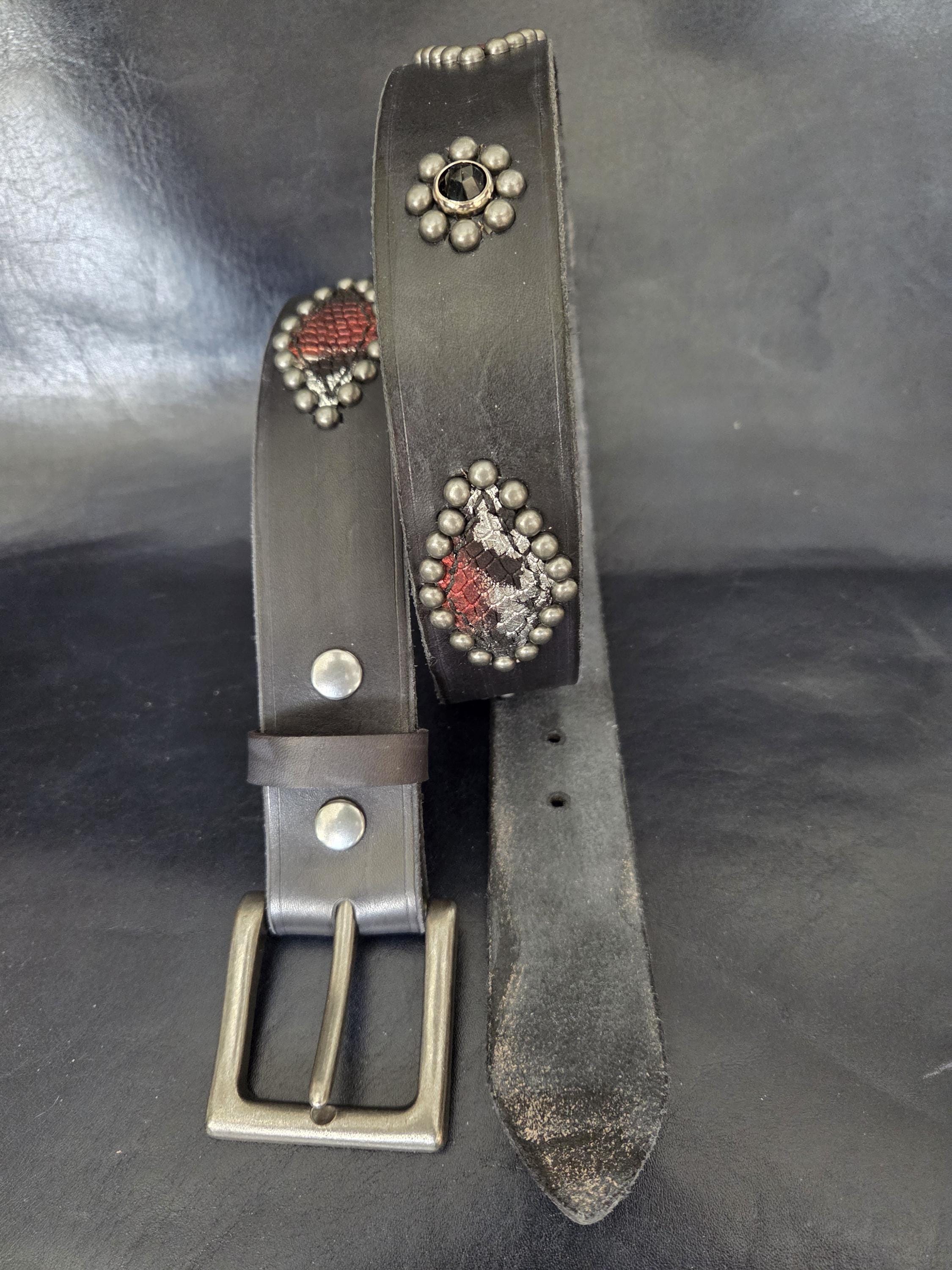 Handmade distressed leather belt with snakeskin print inlays.