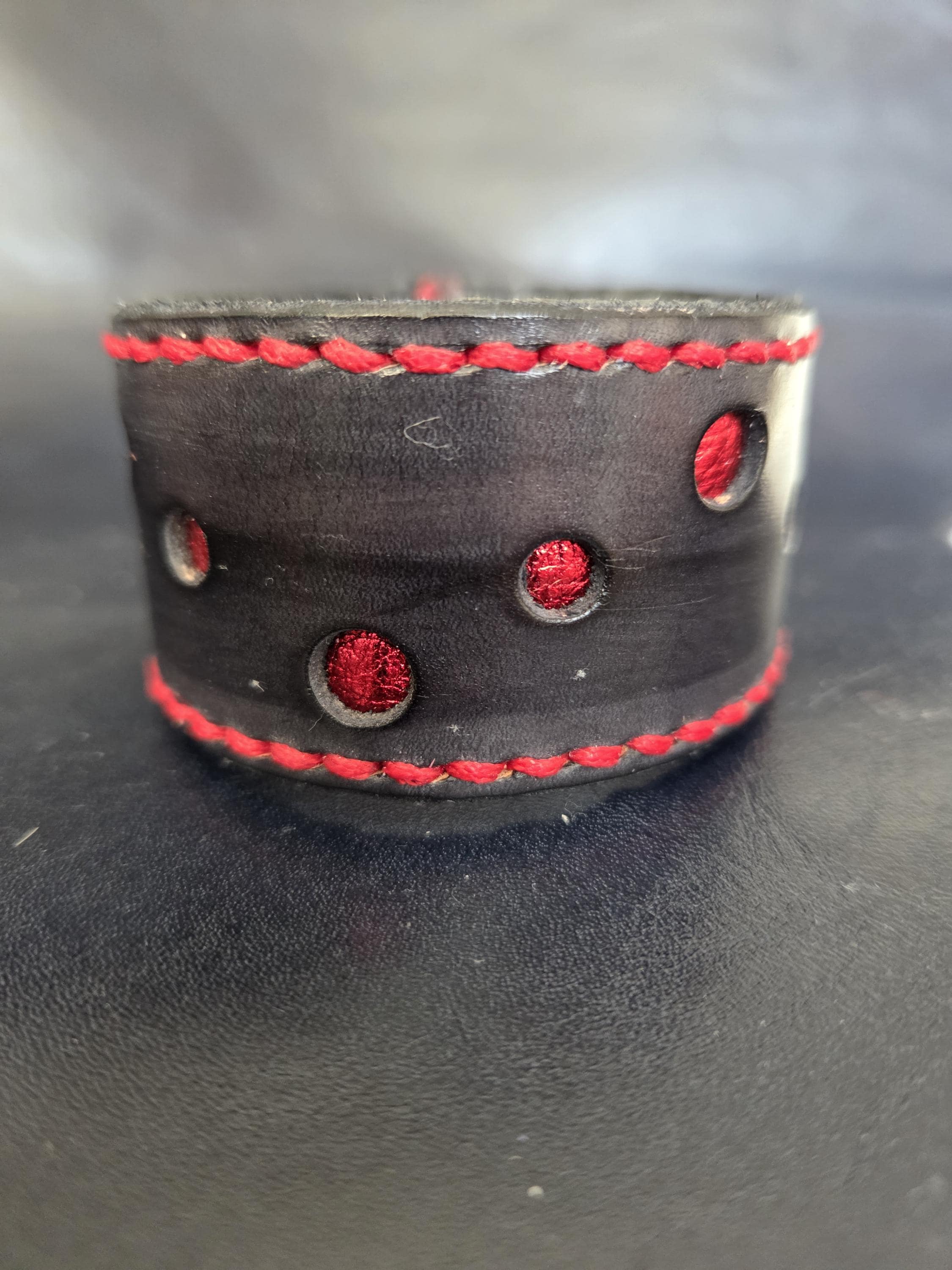 Black and red leather wrist cuff.