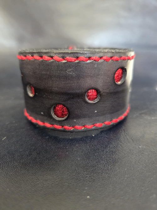 Black and red leather wrist cuff.