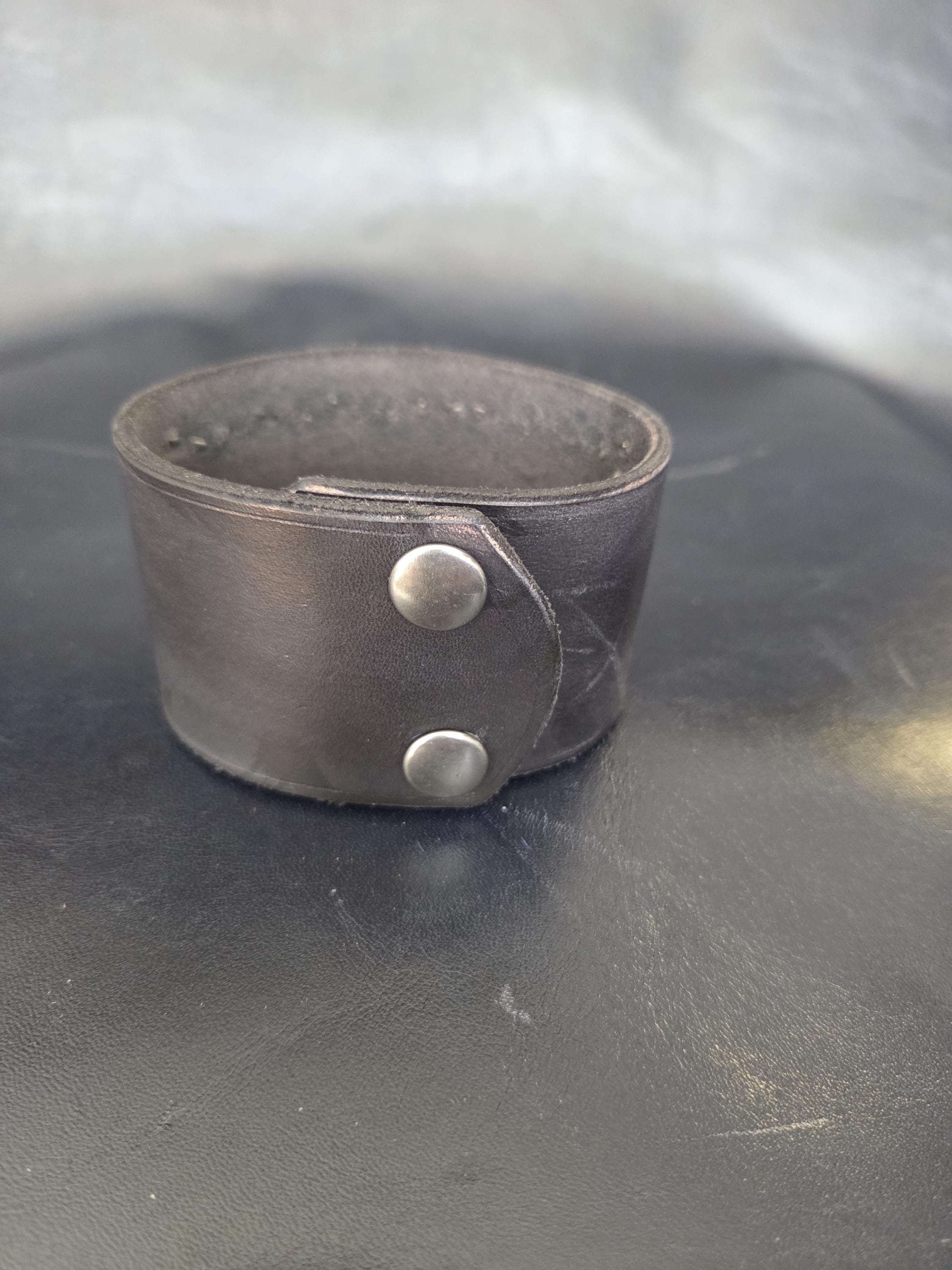 Studded wristband with navy blue hair-on-hide leather.