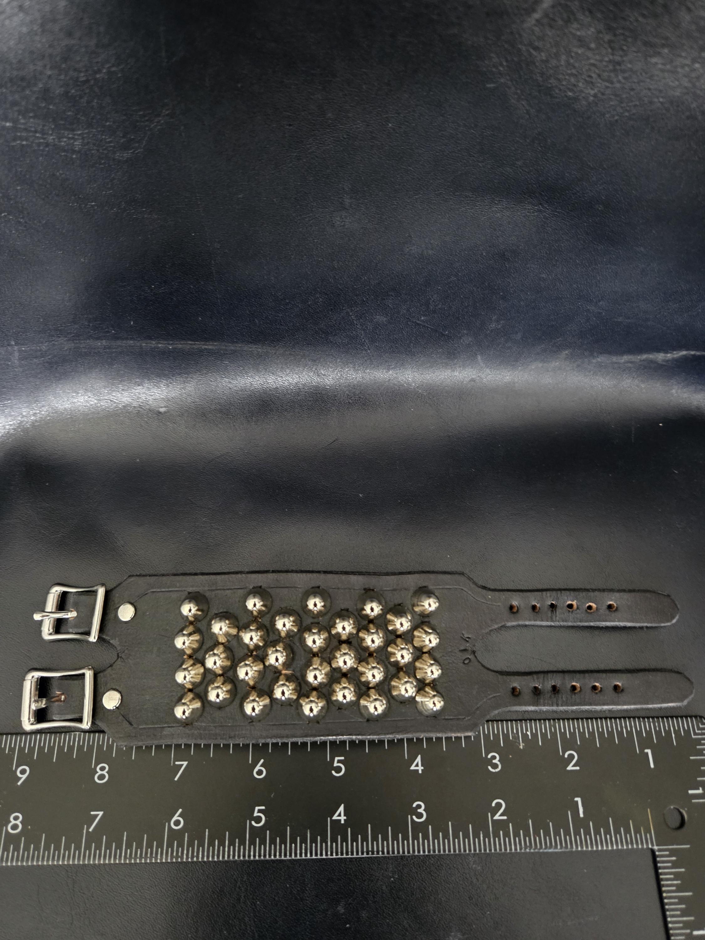 Punk leather studded wrist cuff with buckles.
