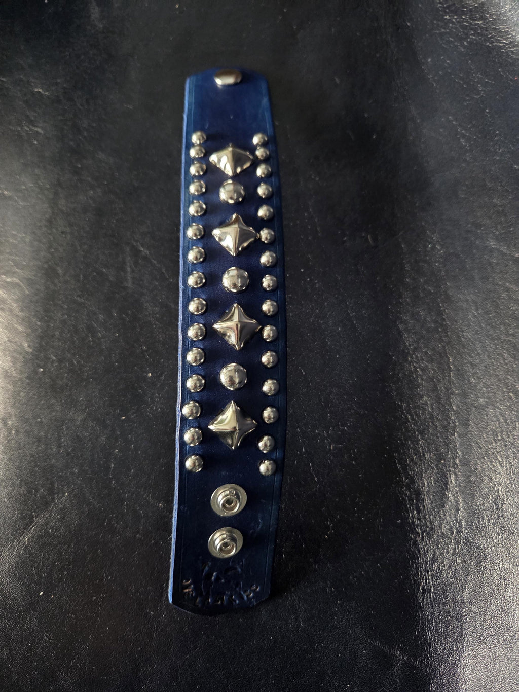 Blue leather wrist cuff.