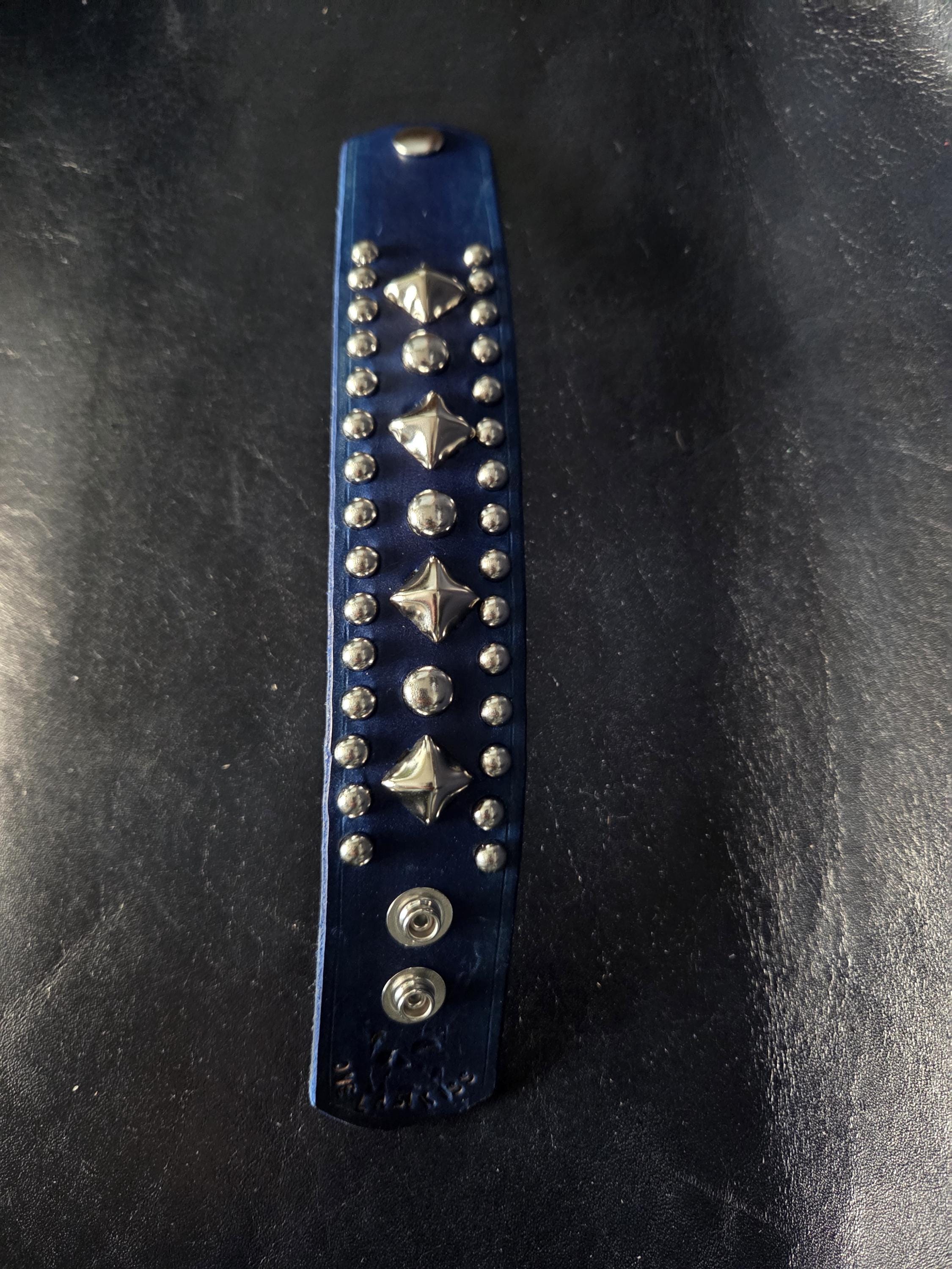 Blue leather wrist cuff.