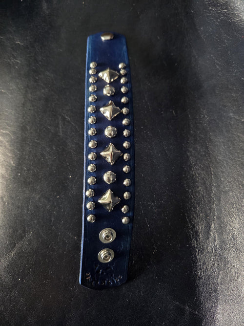 Blue leather wrist cuff.