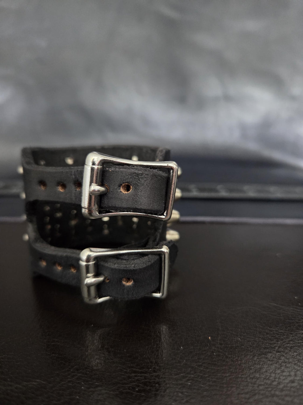Punk leather studded wrist cuff with buckles.