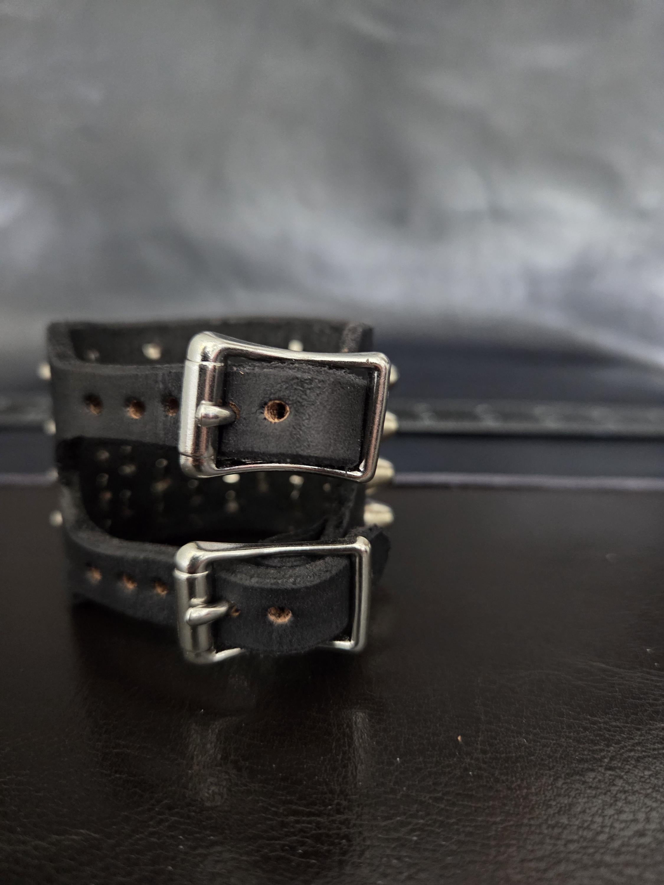 Punk leather studded wrist cuff with buckles.
