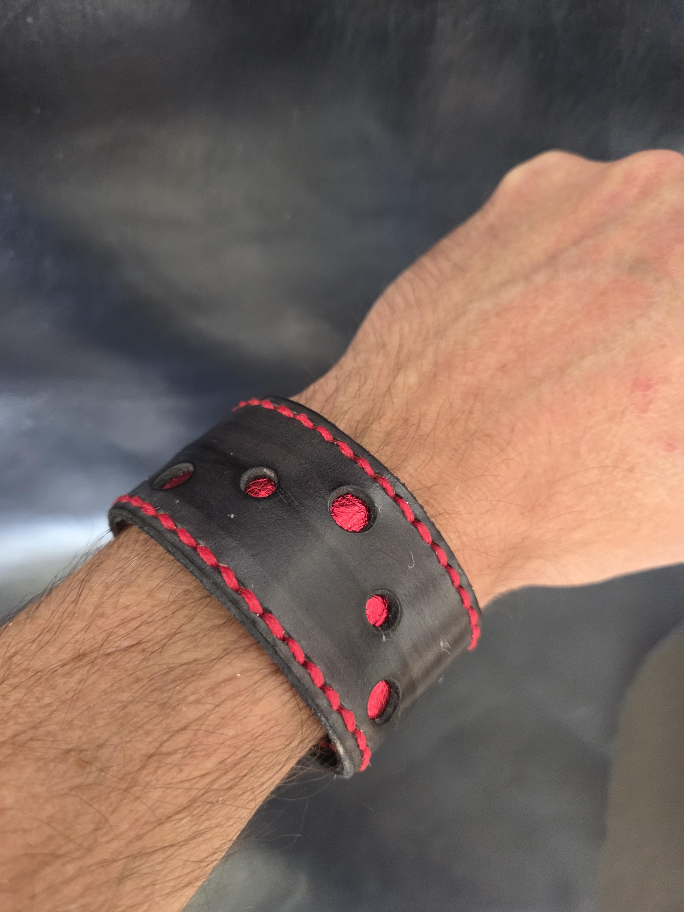 Black and red leather wrist cuff.