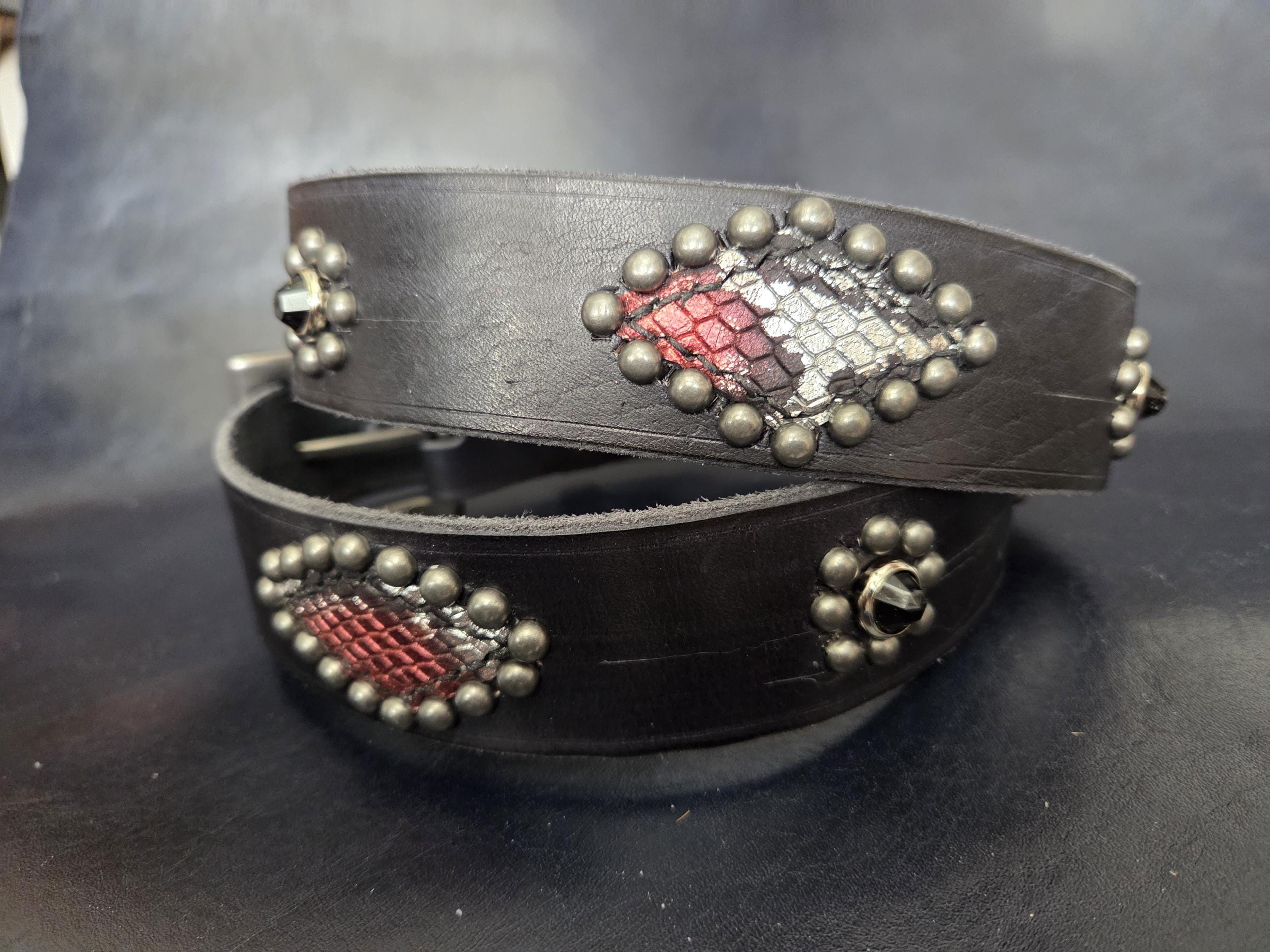 Handmade distressed leather belt with snakeskin print inlays.