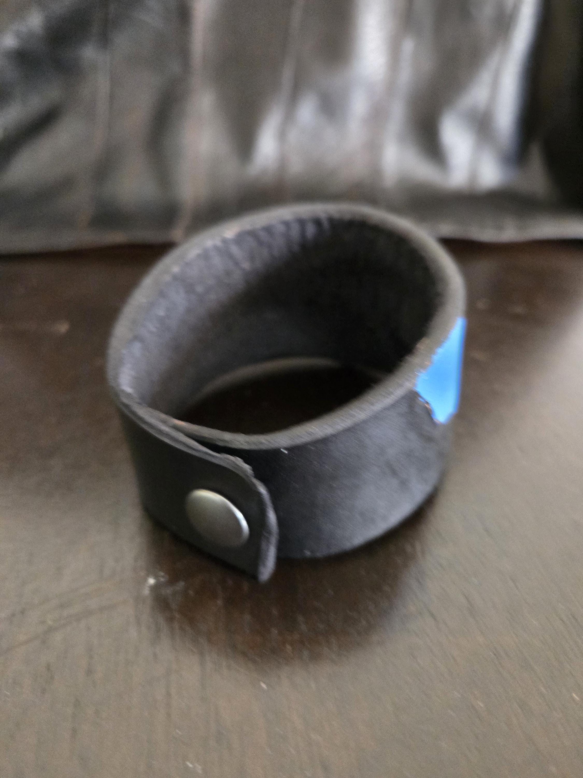 Black n' blue leathet wrist cuff bracelet.