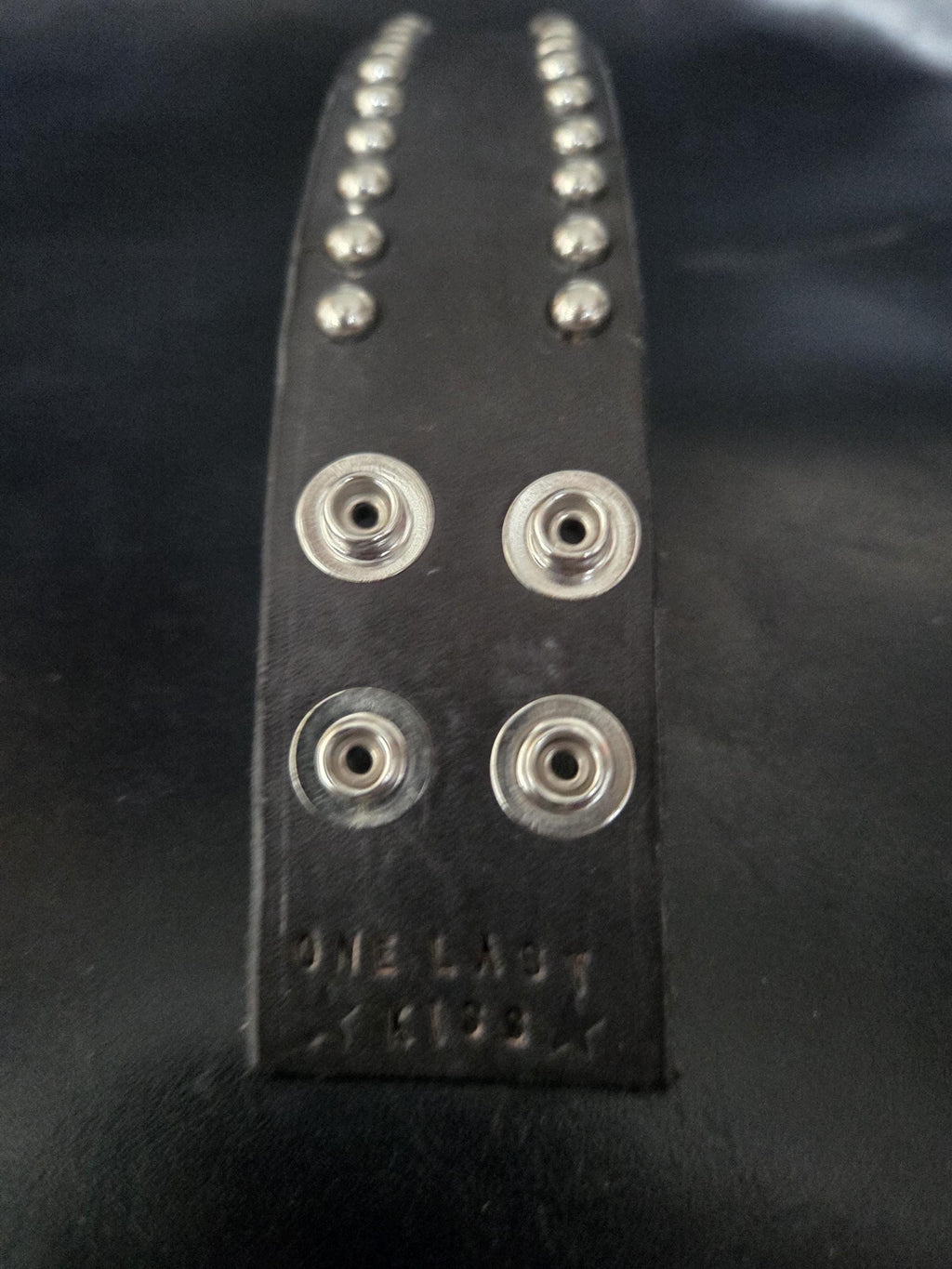 Studded leather wrist cuff.