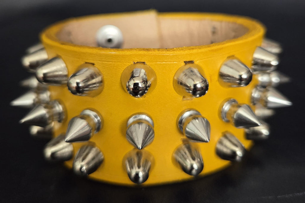 Spiked yellow leather wrist cuff.