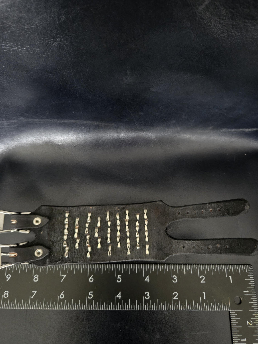 Punk leather studded wrist cuff with buckles.