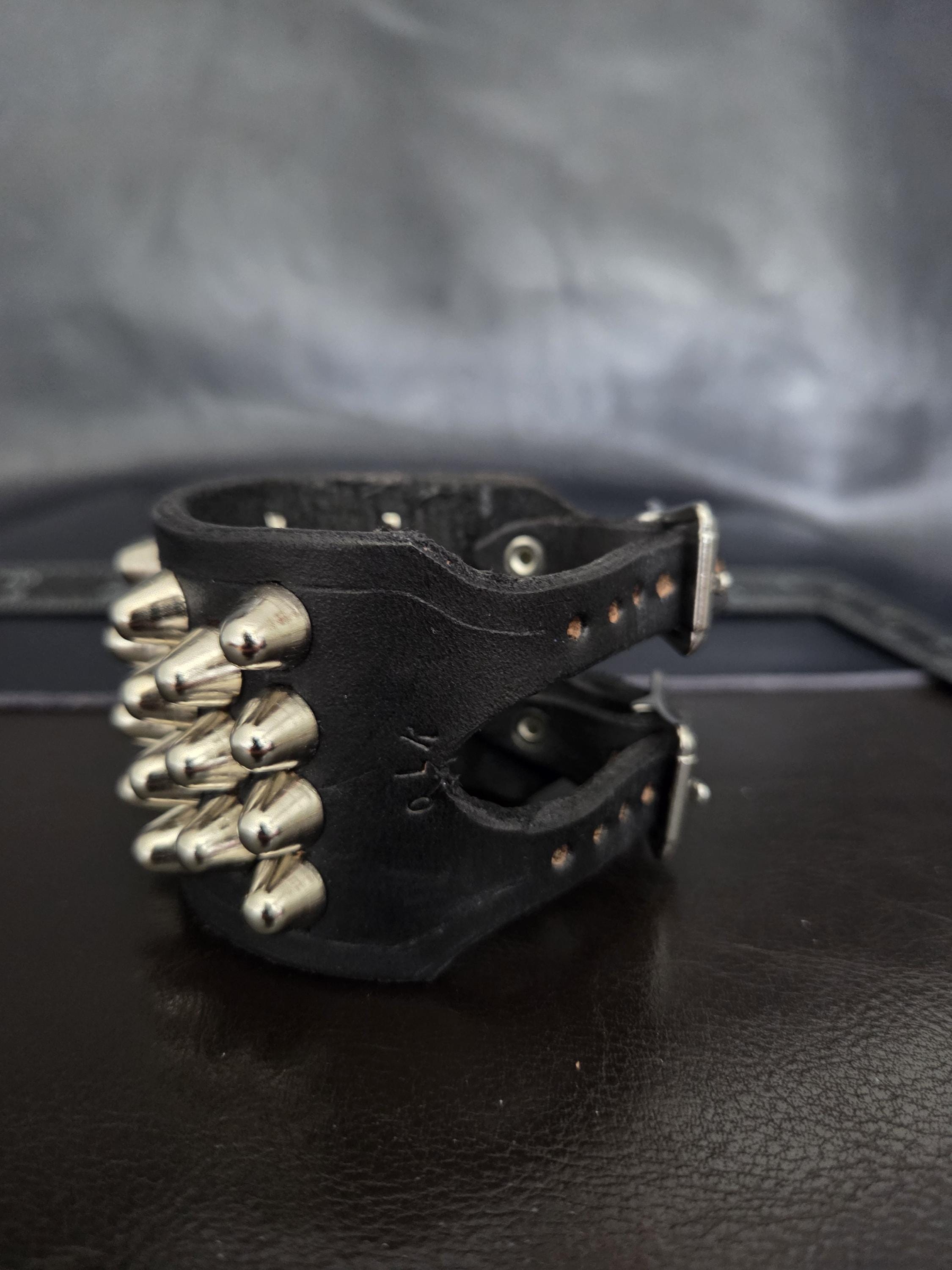 Punk leather studded wrist cuff with buckles.