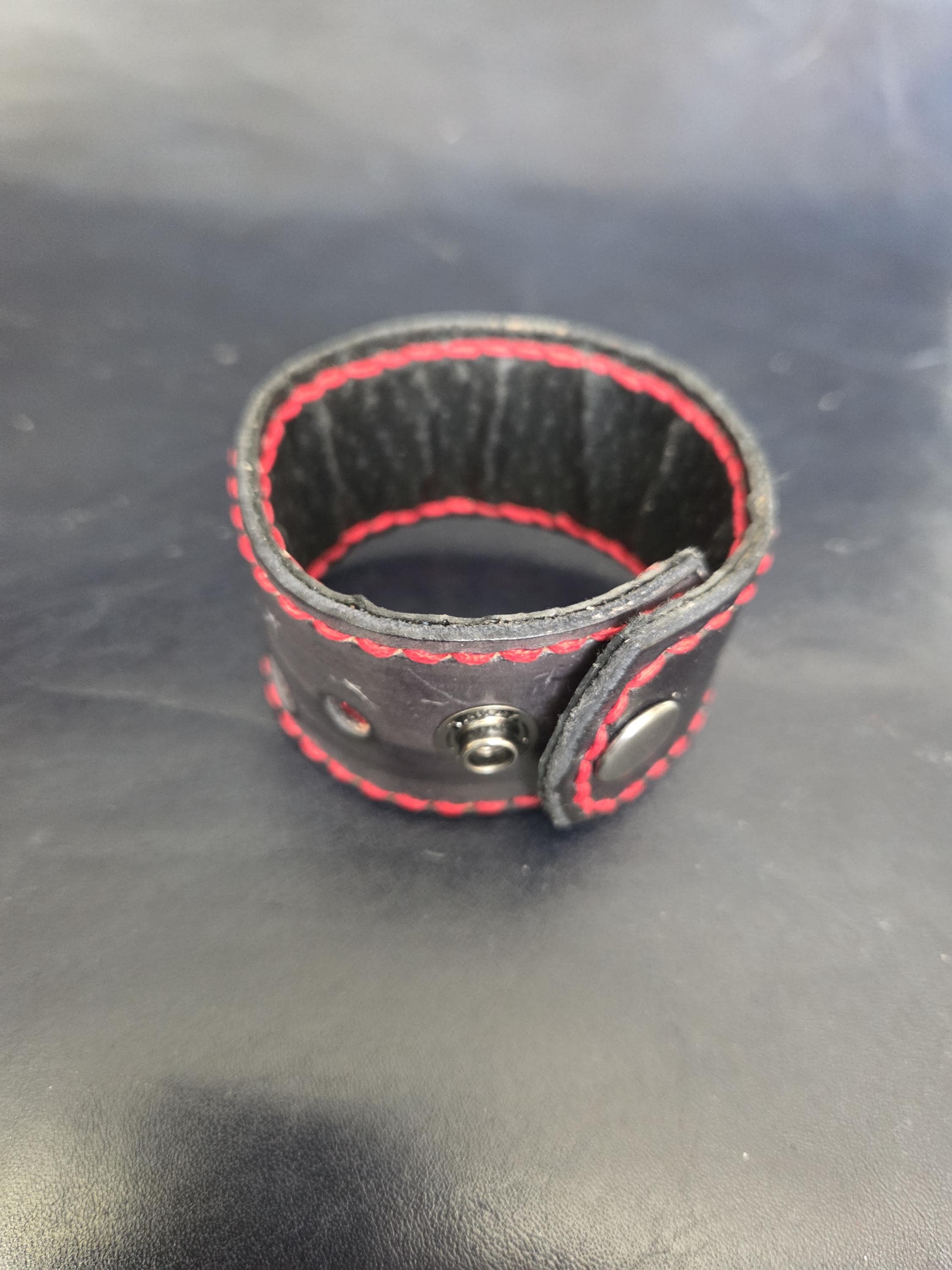 Black and red leather wrist cuff.
