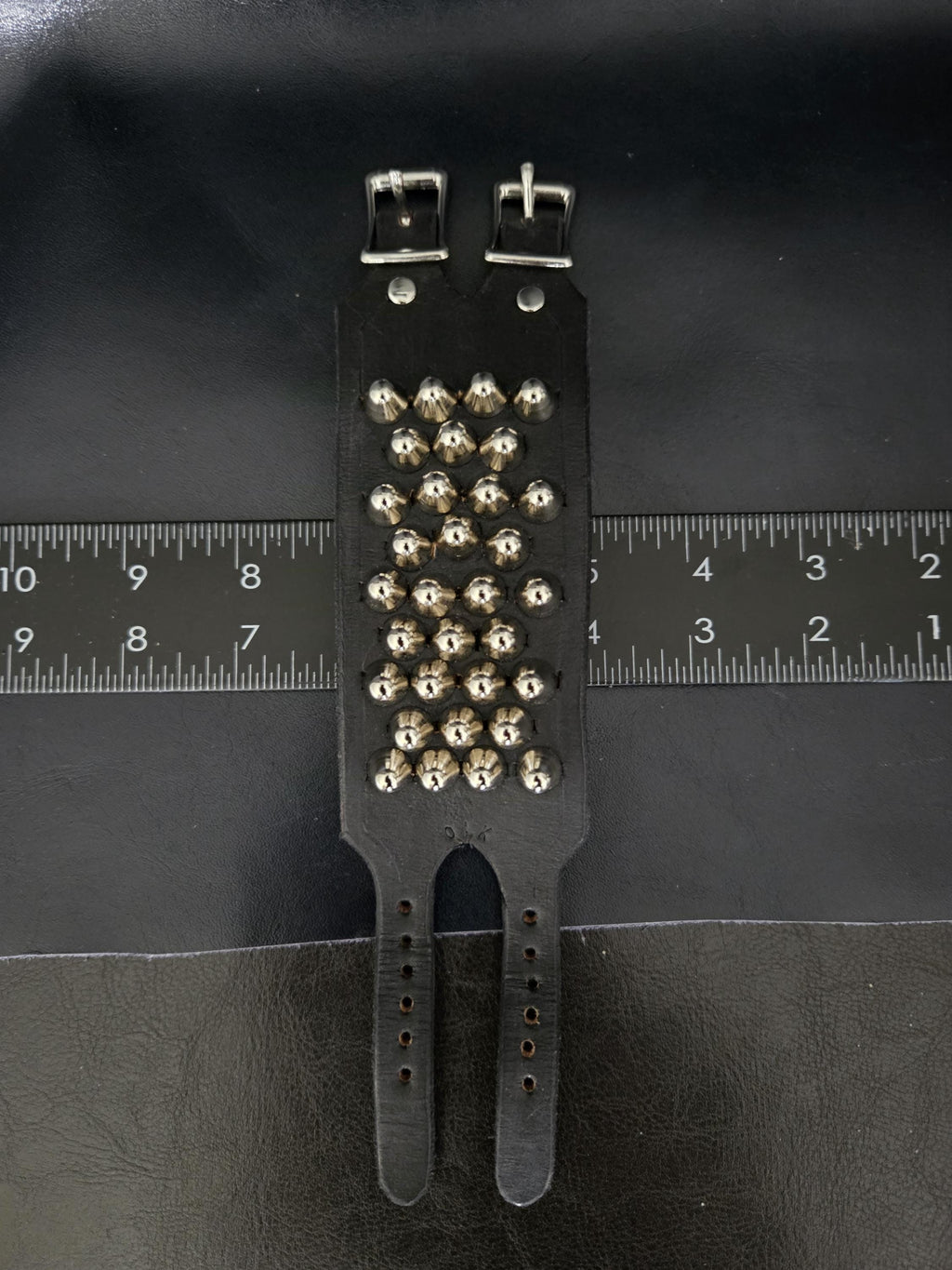 Punk leather studded wrist cuff with buckles.