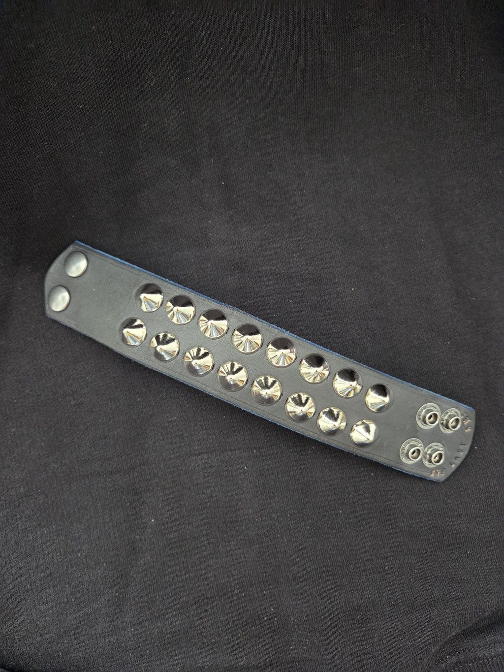 Studded leather punk wrist cuff.