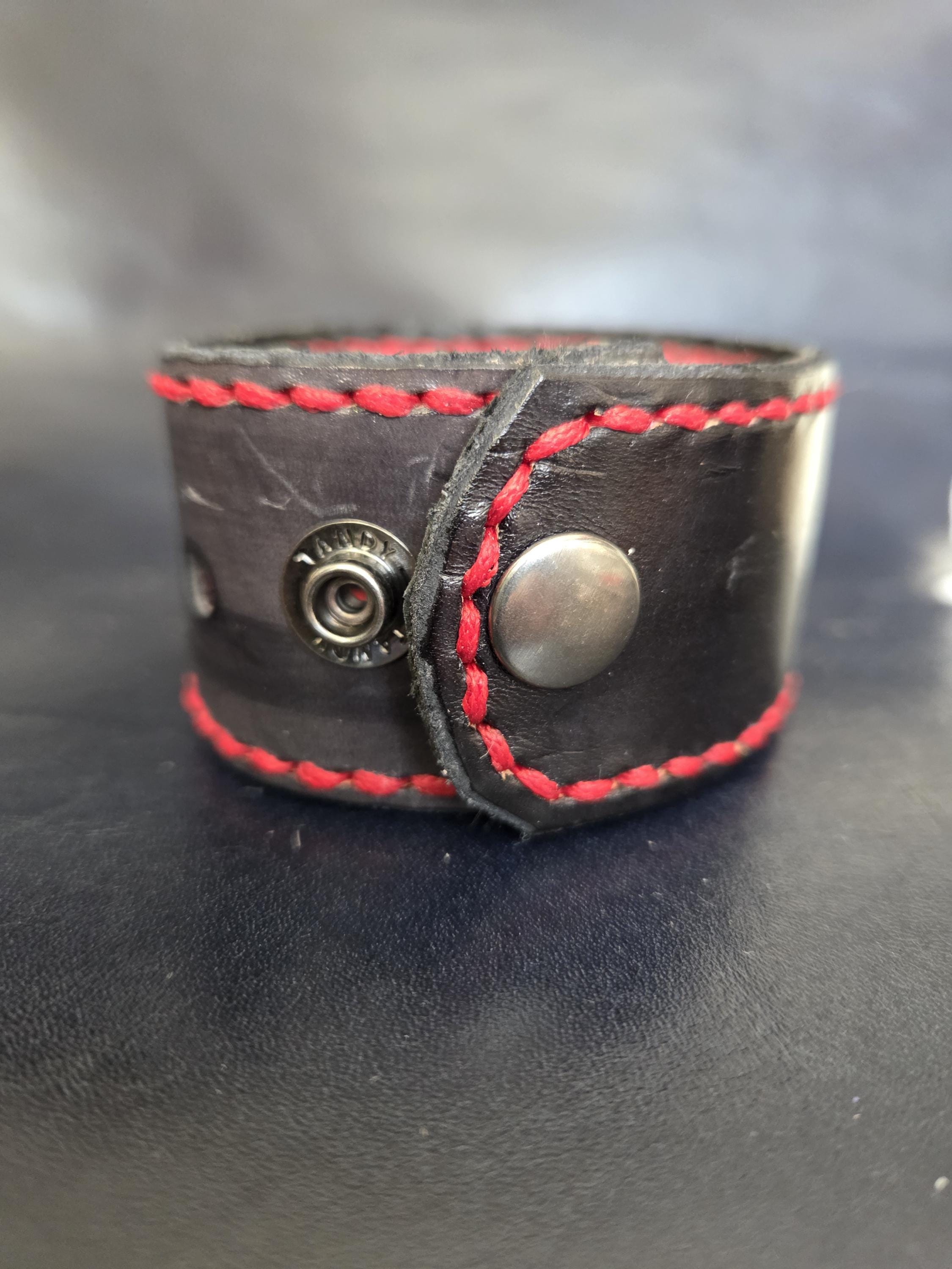 Black and red leather wrist cuff.