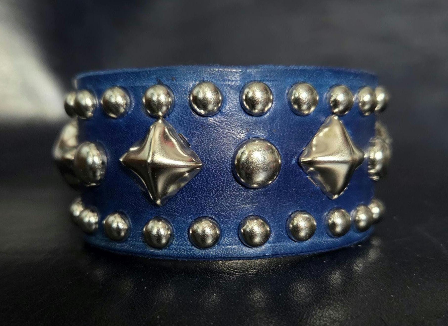 Blue leather wrist cuff.
