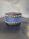 Studded wristband with navy blue hair-on-hide leather.