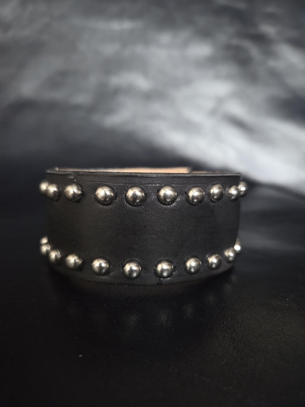 Studded leather wrist cuff.