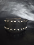 Studded leather wrist cuff.