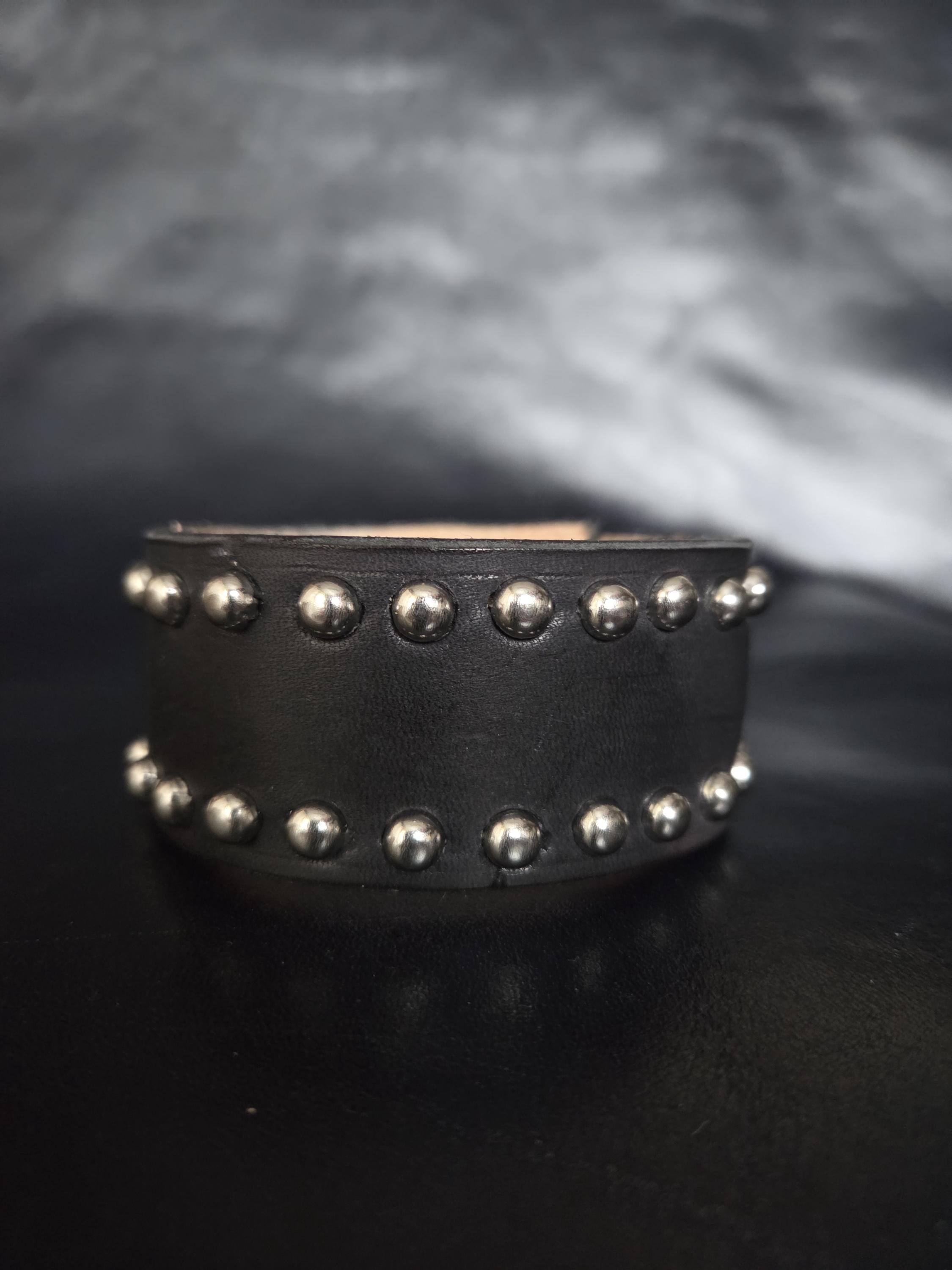 Studded leather wrist cuff.